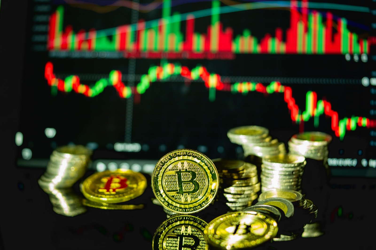 Golden bitcoins stacked in front of a fluctuating financial chart, symbolizing cryptocurrency trading.